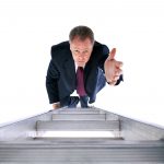 A man in a suit and tie climbing up some stairs